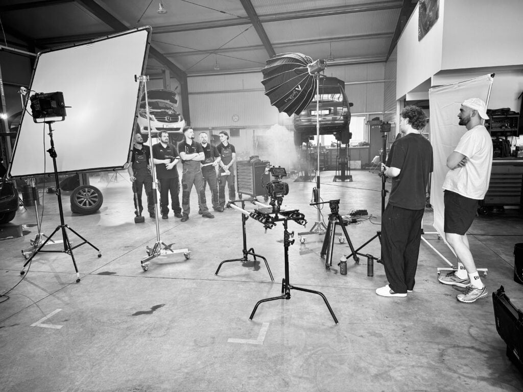 A black and white photo of people in a studio.